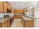 Spacious kitchen featuring stainless appliances, granite countertops, tiled floors and ample wood cabinets at 1892 Sanderling Dr, Clermont, FL 34711
