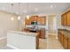 Bright kitchen featuring granite countertops, stainless steel appliances, and wood cabinetry at 1892 Sanderling Dr, Clermont, FL 34711