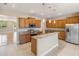 Well-equipped kitchen featuring stainless steel appliances, granite counters, and an island with a sink at 1892 Sanderling Dr, Clermont, FL 34711