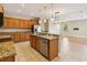 Spacious kitchen features granite countertops, tile floors, stainless steel appliances, and an open floor plan at 1892 Sanderling Dr, Clermont, FL 34711