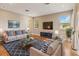 Bright living room with hardwood floors, stylish furniture, and large windows for natural light at 1892 Sanderling Dr, Clermont, FL 34711