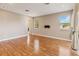 Spacious living room with hardwood floors, many windows, and neutral paint at 1892 Sanderling Dr, Clermont, FL 34711