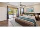 Spacious bedroom featuring a ceiling fan, ample natural light, and access to outdoor patio at 1892 Sanderling Dr, Clermont, FL 34711