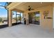 Covered patio with a ceiling fan, outdoor grill, and sliding glass doors leading to the interior at 1892 Sanderling Dr, Clermont, FL 34711