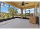 Screened patio with fan, outdoor grill and views of lush greenery at 1892 Sanderling Dr, Clermont, FL 34711