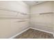 Spacious walk-in closet features white wire shelving and wood-look flooring at 1892 Sanderling Dr, Clermont, FL 34711