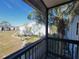 Screened balcony view with blue skies, palm trees, and a lovely grassy lawn area at 3700 Idlebrook Cir # 206, Casselberry, FL 32707