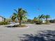 Community entrance features palm trees, an American flag, and ample parking at 3700 Idlebrook Cir # 206, Casselberry, FL 32707