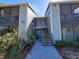Condominium exterior featuring stairs leading to the units with well-maintained landscaping at 3700 Idlebrook Cir # 206, Casselberry, FL 32707