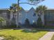 Well-kept two-story condo building featuring light blue siding and complemented by vibrant green lawn and mature trees at 3700 Idlebrook Cir # 206, Casselberry, FL 32707