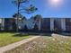 Charming condo building with blue siding, palm trees, and well-maintained landscaping under a clear blue sky at 3700 Idlebrook Cir # 206, Casselberry, FL 32707