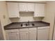 Clean and functional kitchen with essential appliances, neutral countertops and ample cabinet space for storage at 3700 Idlebrook Cir # 206, Casselberry, FL 32707
