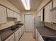Functional kitchen with white cabinets, sleek countertops, and modern appliances for easy meal preparation at 3700 Idlebrook Cir # 206, Casselberry, FL 32707