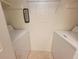 Functional laundry area with white washer and dryer units, offering convenience and efficiency at 3700 Idlebrook Cir # 206, Casselberry, FL 32707