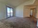 Bright living room with neutral carpet, sliding glass doors to a balcony, and convenient closet space at 3700 Idlebrook Cir # 206, Casselberry, FL 32707