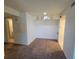 Empty living room ready for customization, featuring neutral carpet, cubbies, and access to other rooms at 3700 Idlebrook Cir # 206, Casselberry, FL 32707