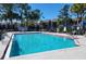 Community pool with crystal clear blue water and lounge chairs surrounding at 3700 Idlebrook Cir # 206, Casselberry, FL 32707