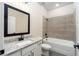 Bathroom with granite counters, white cabinets, black hardware, a tiled shower, and a bathtub at 7701 Somersworth Dr, Kissimmee, FL 34747