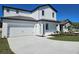 Charming two-story home featuring a two-car garage, manicured lawn, and beautifully painted exterior at 1653 Nantucket Way, Winter Haven, FL 33884