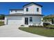 Charming two-story home featuring a two-car garage, manicured lawn, and beautifully painted exterior at 1653 Nantucket Way, Winter Haven, FL 33884