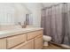 This bathroom is equipped with a vanity sink, and a shower behind a grey shower curtain at 3930 Cassia Dr, Orlando, FL 32828