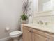 Well-lit half bathroom with a decorative flower accent and neutral finishes at 3930 Cassia Dr, Orlando, FL 32828