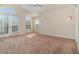 Bright, airy bedroom with french doors, many windows, and neutral carpeting at 3930 Cassia Dr, Orlando, FL 32828