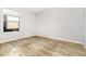 Bedroom with wood-look floors and a bright window providing ample natural light at 3930 Cassia Dr, Orlando, FL 32828