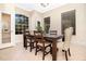 Cozy dining room featuring a dark wood table, comfortable seating and natural light from large windows at 3930 Cassia Dr, Orlando, FL 32828