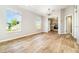 Bright dining area with wood floors next to kitchen with stainless appliances and cabinets at 3930 Cassia Dr, Orlando, FL 32828