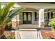 Inviting front porch with double doors and decorative stone pillars at 3930 Cassia Dr, Orlando, FL 32828