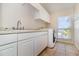 Laundry room with plenty of counter space and a utility sink for easy cleaning and organization at 3930 Cassia Dr, Orlando, FL 32828