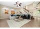 Inviting living room featuring staircase, tile floors, and open floor plan perfect for Gathering at 3930 Cassia Dr, Orlando, FL 32828