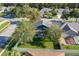 Aerial shot of backyard with screen porch and fenced yard surrounded by lush trees and neighborhood homes at 14610 Astina Way, Orlando, FL 32837