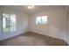 Bright bedroom featuring wood-look floors, two windows, and a closet with white walls at 14610 Astina Way, Orlando, FL 32837