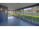 View of a screened-in porch with a concrete floor and backyard view through the screens at 14610 Astina Way, Orlando, FL 32837