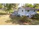Spacious backyard with a patio area, mature trees, and a chain-link fence at 1326 Se 34Th Ter, Ocala, FL 34471