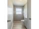 Bathroom featuring gray tiled shower, gray walls, a white toilet and shower, and vanity at 1326 Se 34Th Ter, Ocala, FL 34471