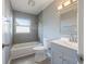 Nicely tiled bathroom featuring gray walls, white toilet and shower, and a bright vanity at 1326 Se 34Th Ter, Ocala, FL 34471