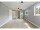 Bedroom with light gray walls, light vinyl floors, closet, ceiling fan and bright natural light at 1326 Se 34Th Ter, Ocala, FL 34471