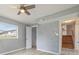 Bedroom with closet, stairs, ceiling fan, and light gray walls and laminate wood flooring at 1326 Se 34Th Ter, Ocala, FL 34471