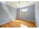 A bright, hardwood-floored bedroom with a ceiling fan and natural light from the window at 1326 Se 34Th Ter, Ocala, FL 34471