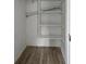 White painted closet with shelving and a wood-look vinyl floor at 1326 Se 34Th Ter, Ocala, FL 34471
