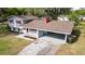 Charming two-story home with a carport, gray siding, and a red chimney at 1326 Se 34Th Ter, Ocala, FL 34471