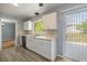 Bright kitchen with white cabinetry, updated countertops, and stainless steel dishwasher at 1326 Se 34Th Ter, Ocala, FL 34471