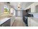 Updated kitchen boasts stainless steel appliances, white cabinets, and modern finishes at 1326 Se 34Th Ter, Ocala, FL 34471