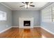 Cozy living room features beautiful hardwood floors and a charming white brick fireplace at 1326 Se 34Th Ter, Ocala, FL 34471