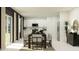 Elegant dining room with modern table and chairs, stainless refrigerator, and access to a covered outdoor space at 2161 Albatross Nest Dr, Bartow, FL 33830