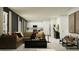 Open living room features a tan sofa, black coffee table, and adjoins an eat-in kitchen at 2161 Albatross Nest Dr, Bartow, FL 33830