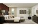 Spacious bedroom showcases decor, neutral colors, bedside tables, and cozy bench seating with a window view at 2161 Albatross Nest Dr, Bartow, FL 33830